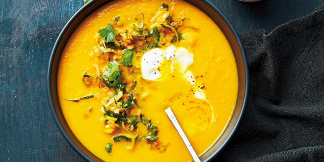 a garnished bowl of carrot soup