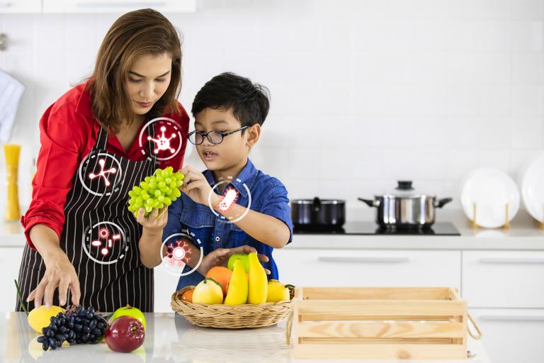 A mother and son in the kitchen choosing probiotic fruits